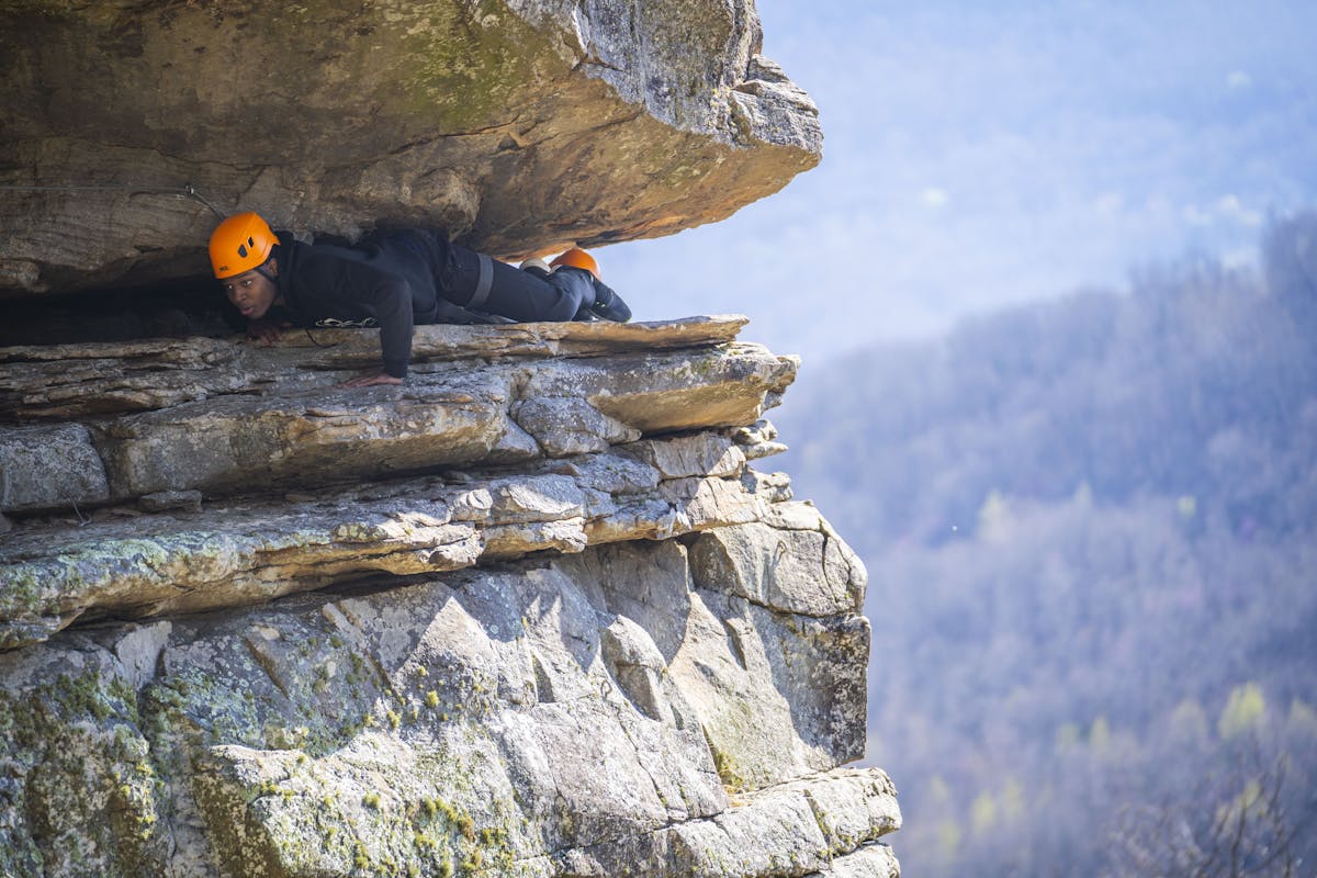 a person sitting on a rock