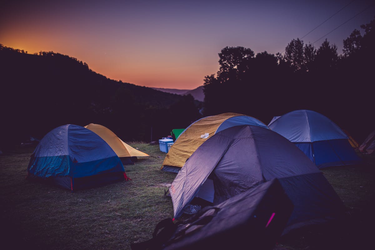 a sunset over a tent