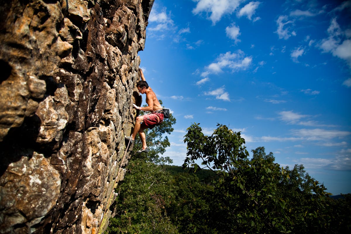 a man standing on a rocky hill