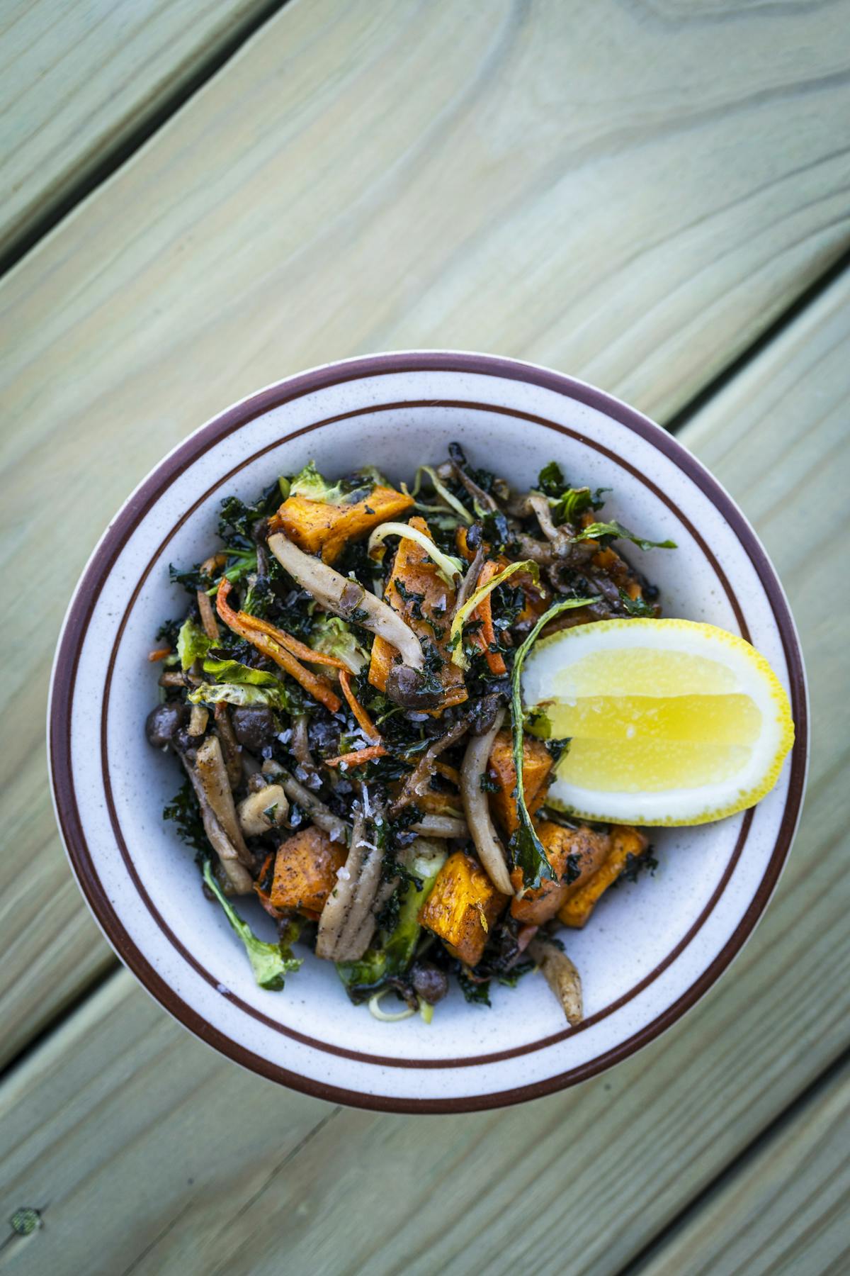 a plate of food sitting on top of a wooden table