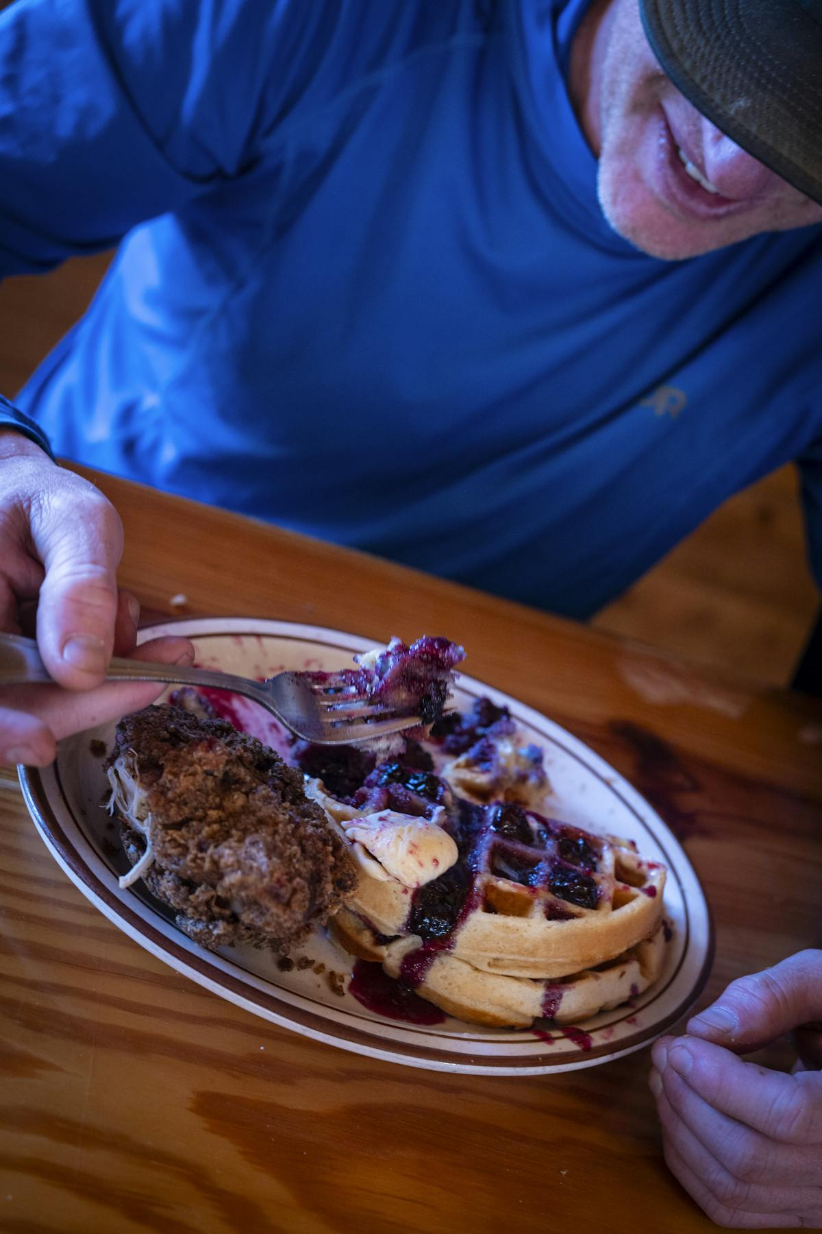 a man sitting at a table with a plate of food