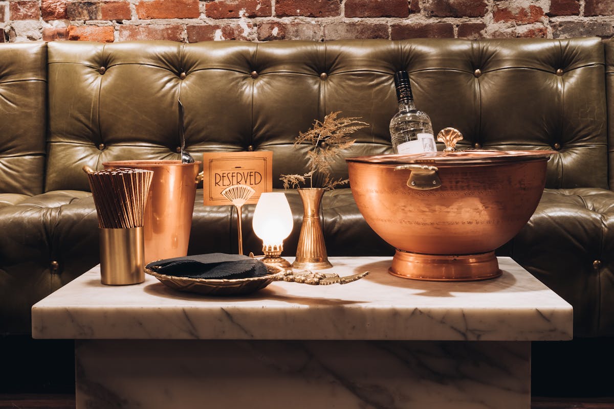 bottle service mossy green booth birthday party best venue Monroe a bowl filled with furniture and vase on a table