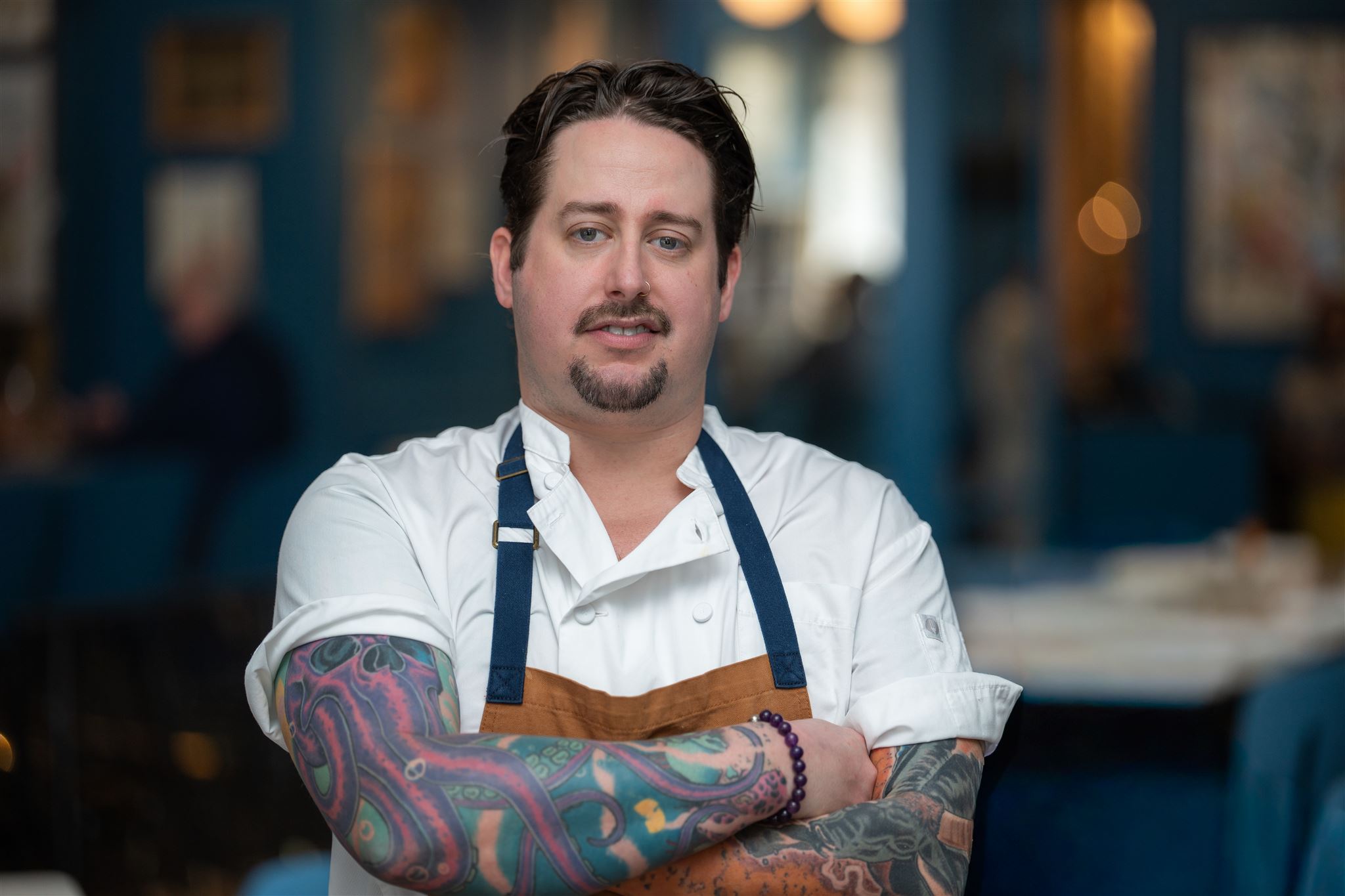 a man with tattoos on his arm