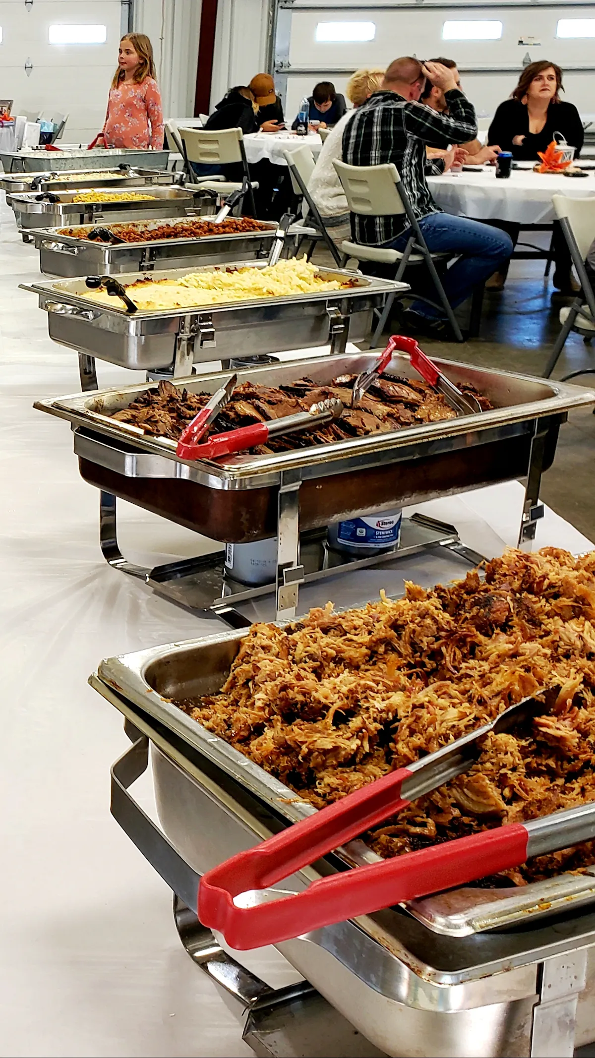 a group of people sitting at a table full of food
