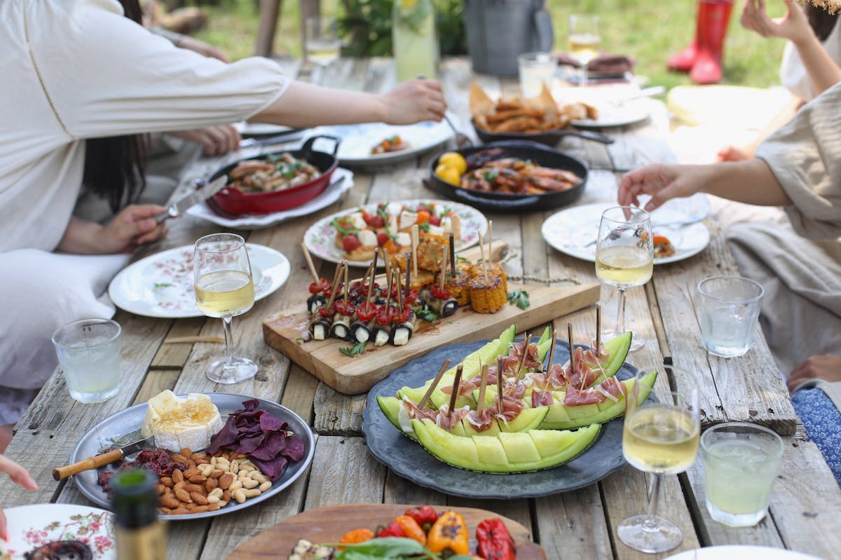 a group of people sitting at a table with a plate of food