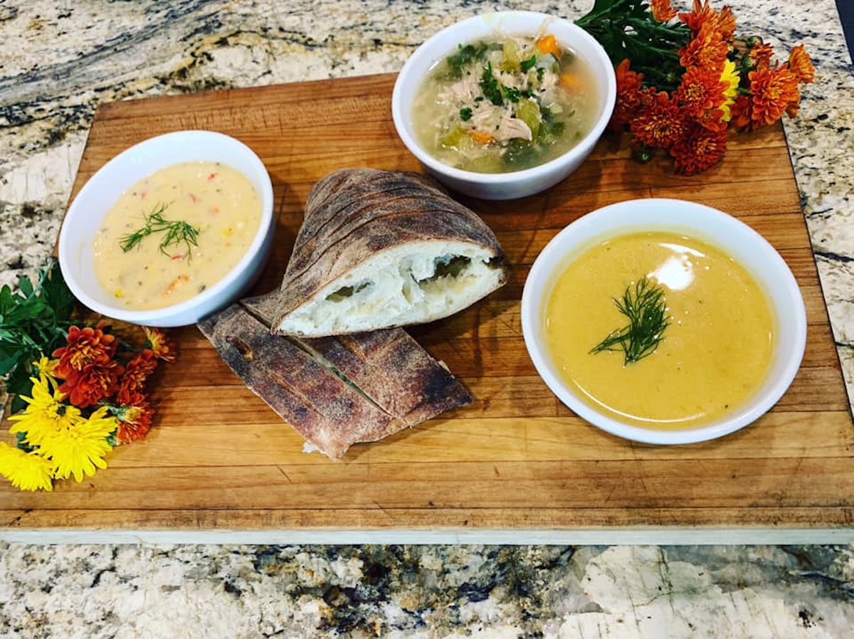 a bowl of food sitting on top of a wooden table