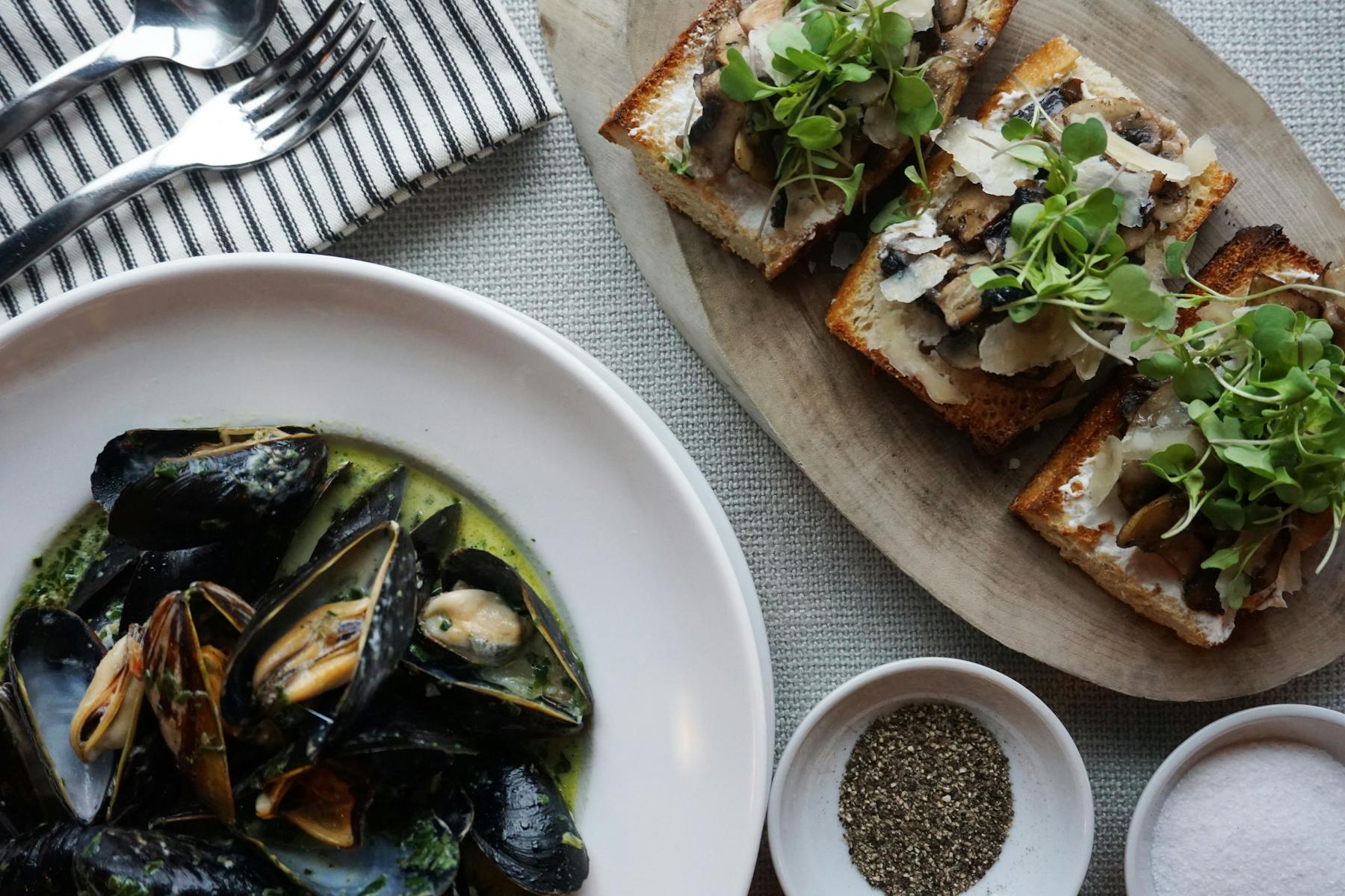 Seafood and toasts served on a table.