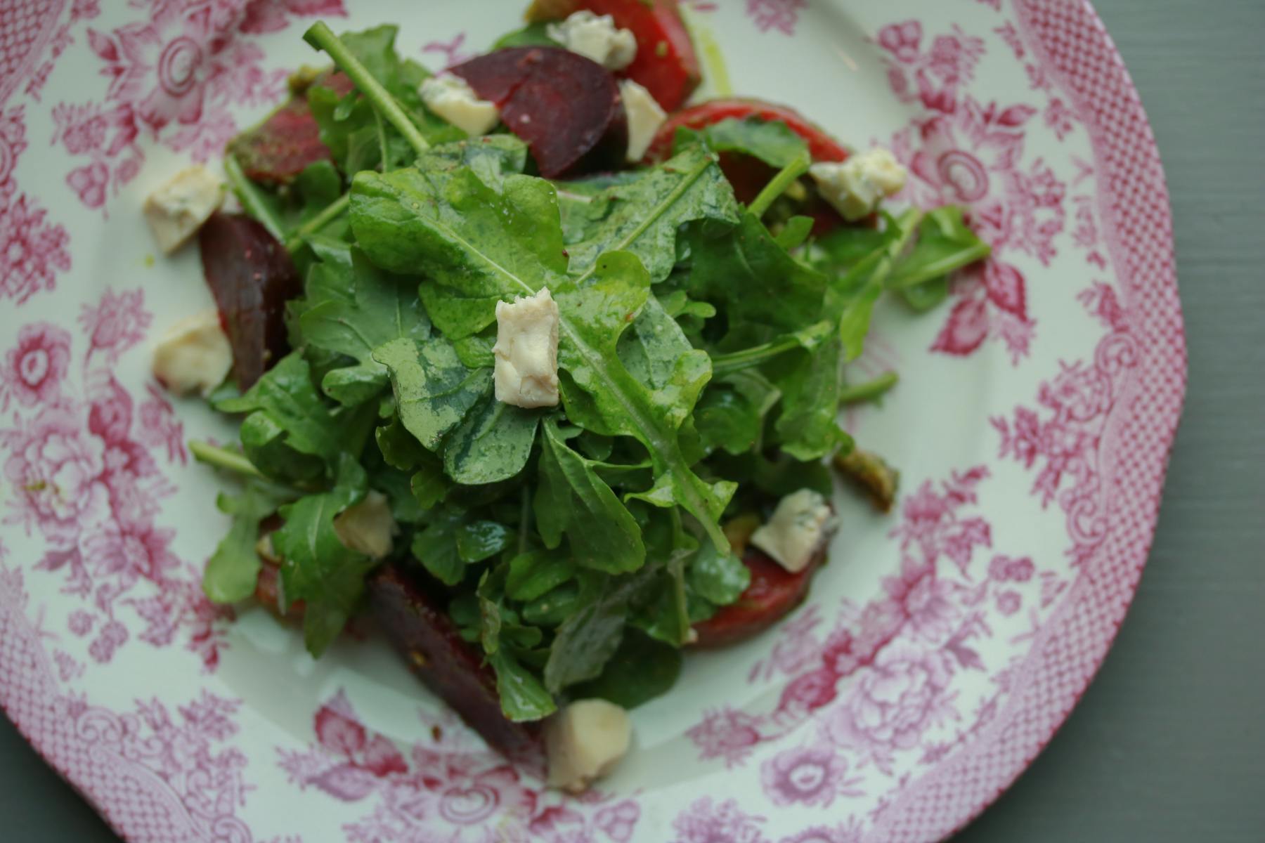 a white plate topped with a sandwich and a salad