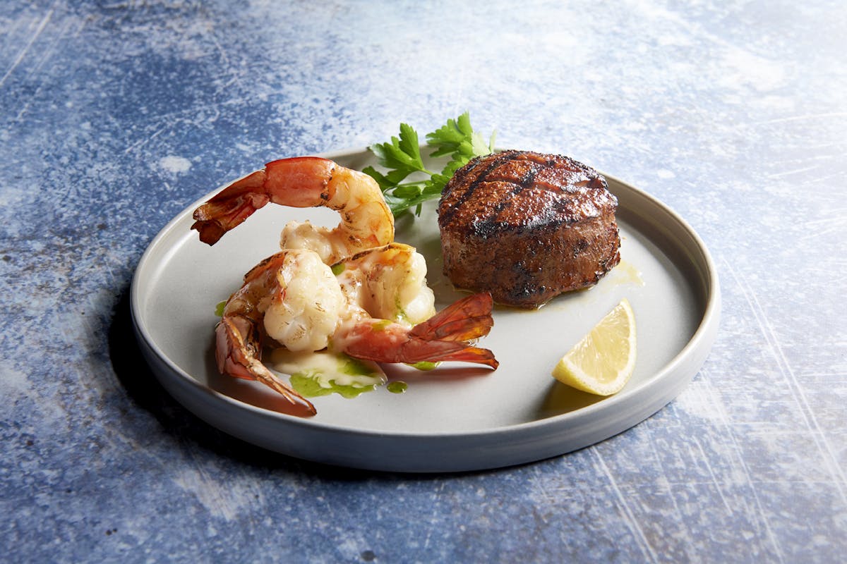 a plate of steak and shrimp