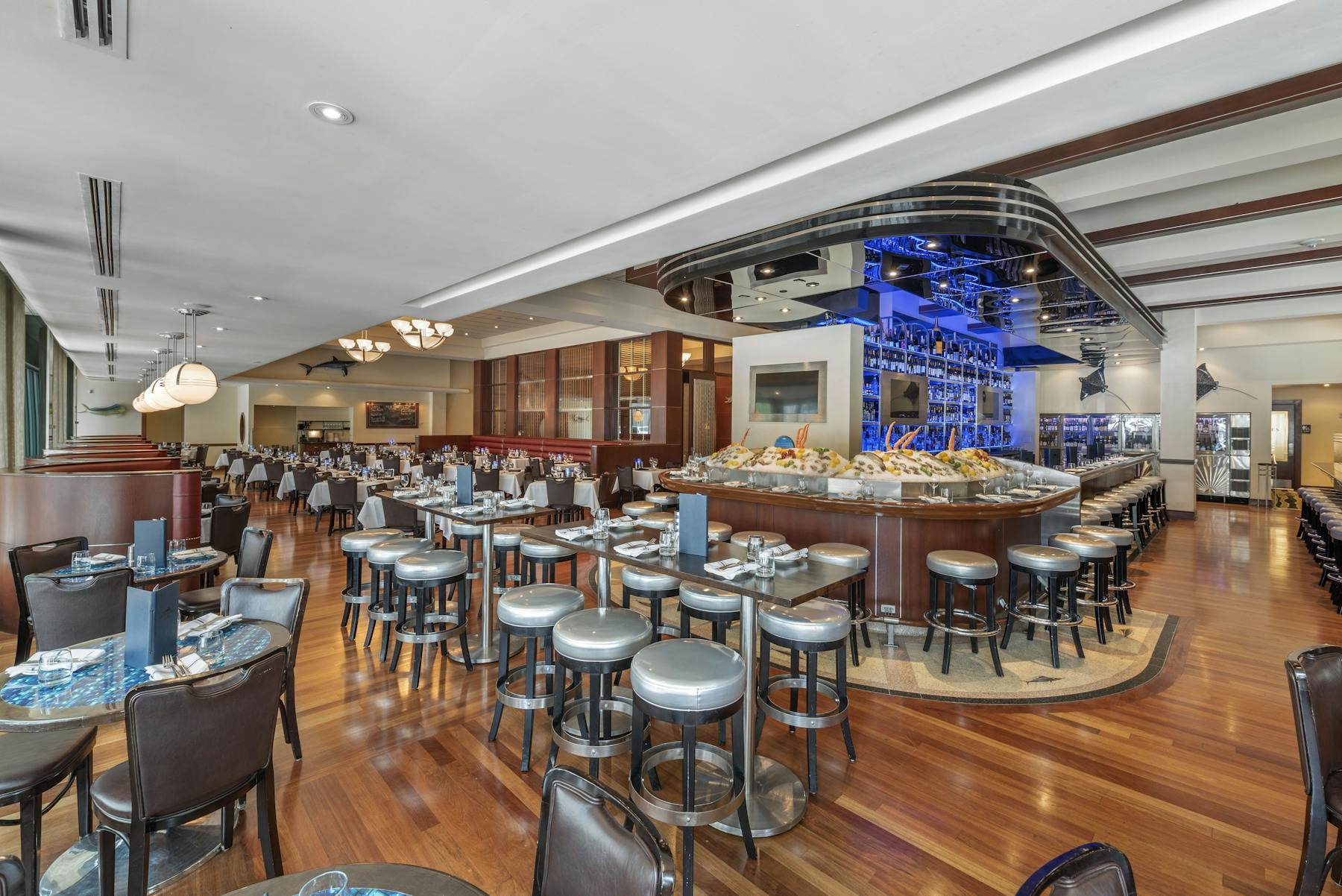 a restaurants bar with large tv screens