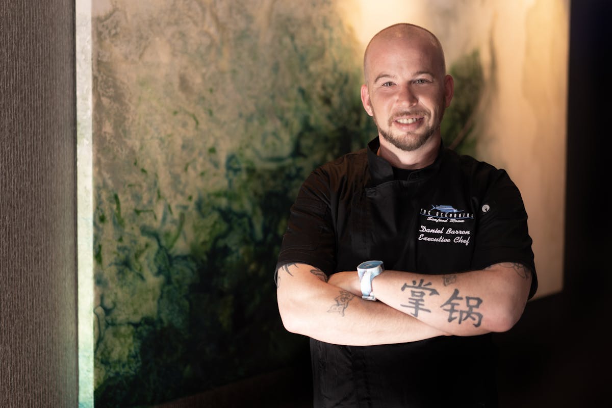 Daniel Barron standing in front of a wall