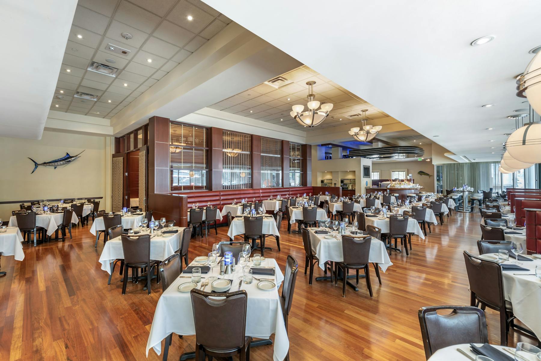 a room filled with dining tables, furniture and a large window