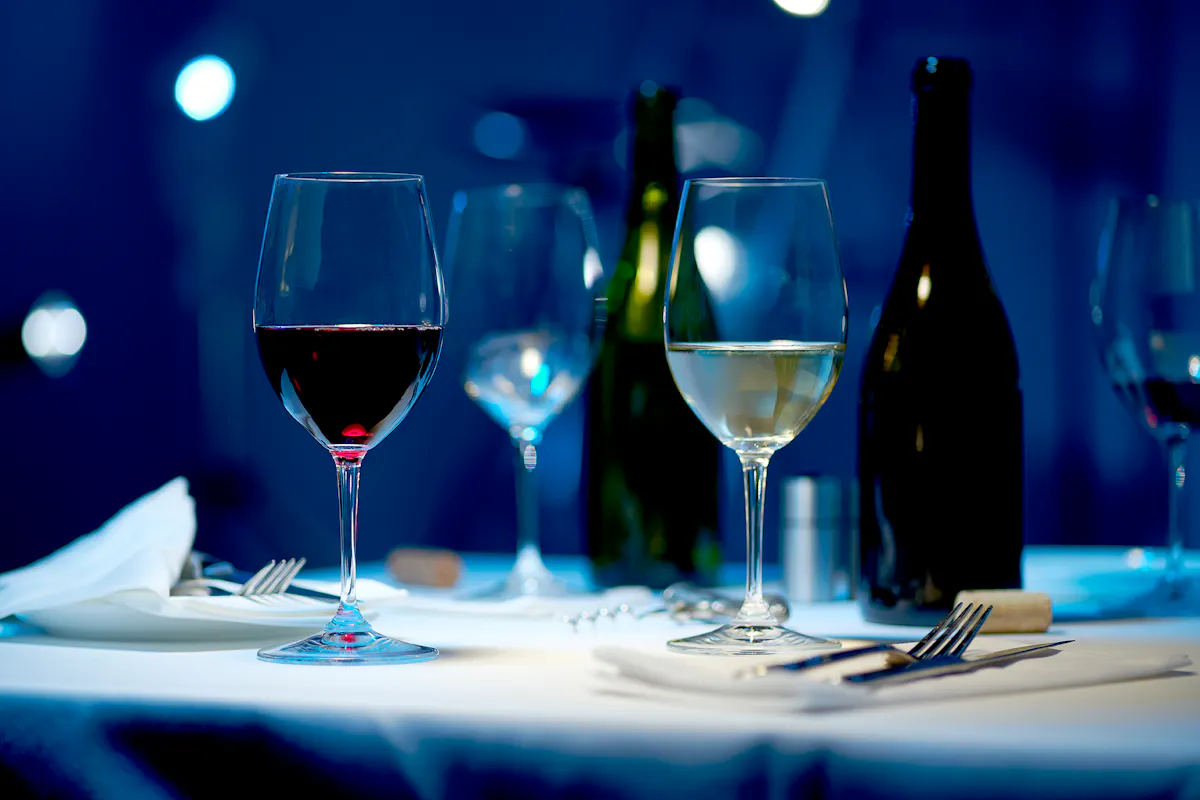 a glass of wine sitting on top of a table