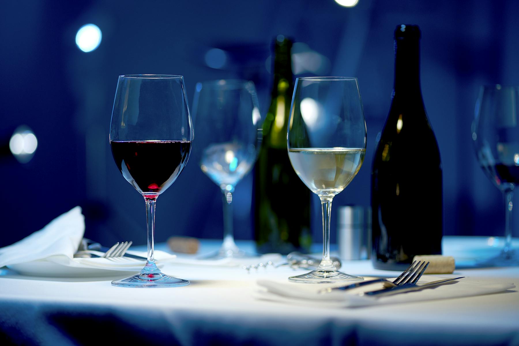 a glass of wine sitting on top of a table
