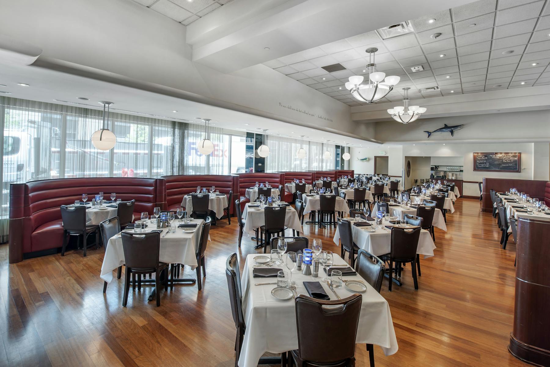 a room filled with dining tables, furniture and a large window