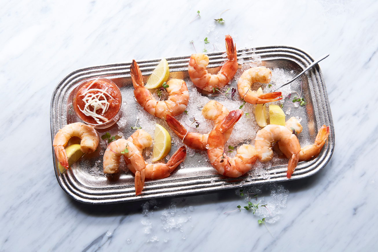 a plate of shrimp and lemons