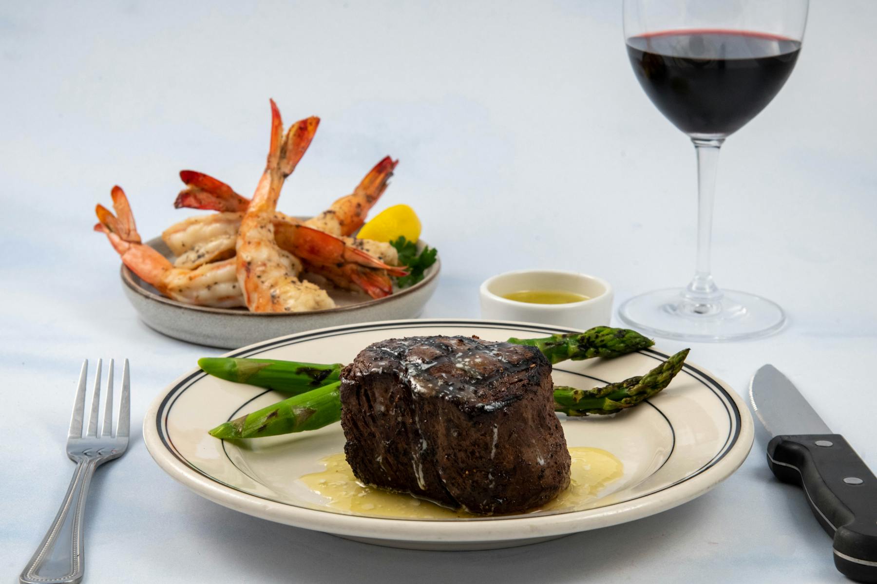 a plate of food and a glass of wine