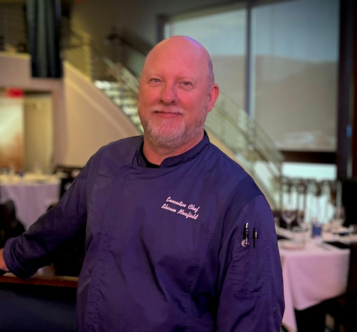 a man standing in front of a table
