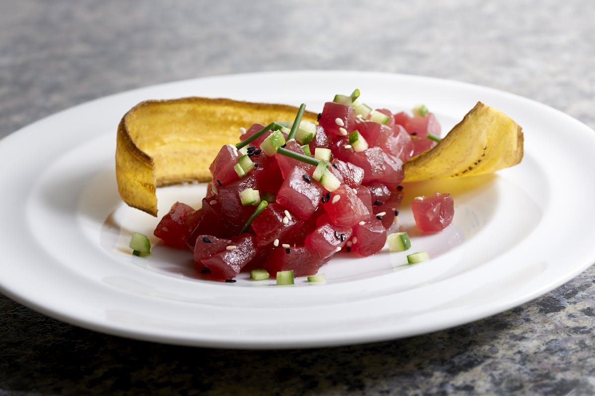 a white plate topped with a piece of fruit