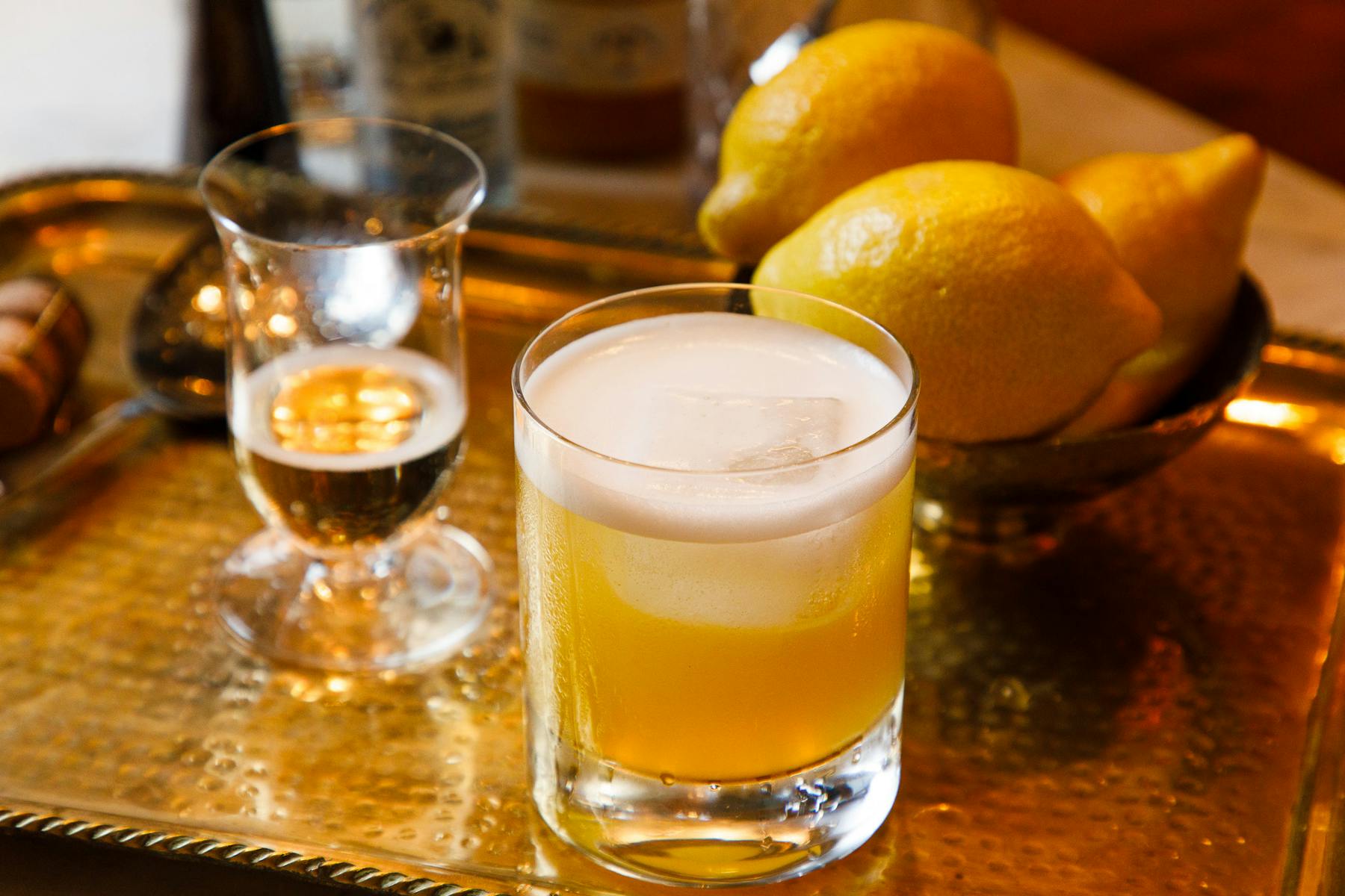 a cocktail on a gold tray