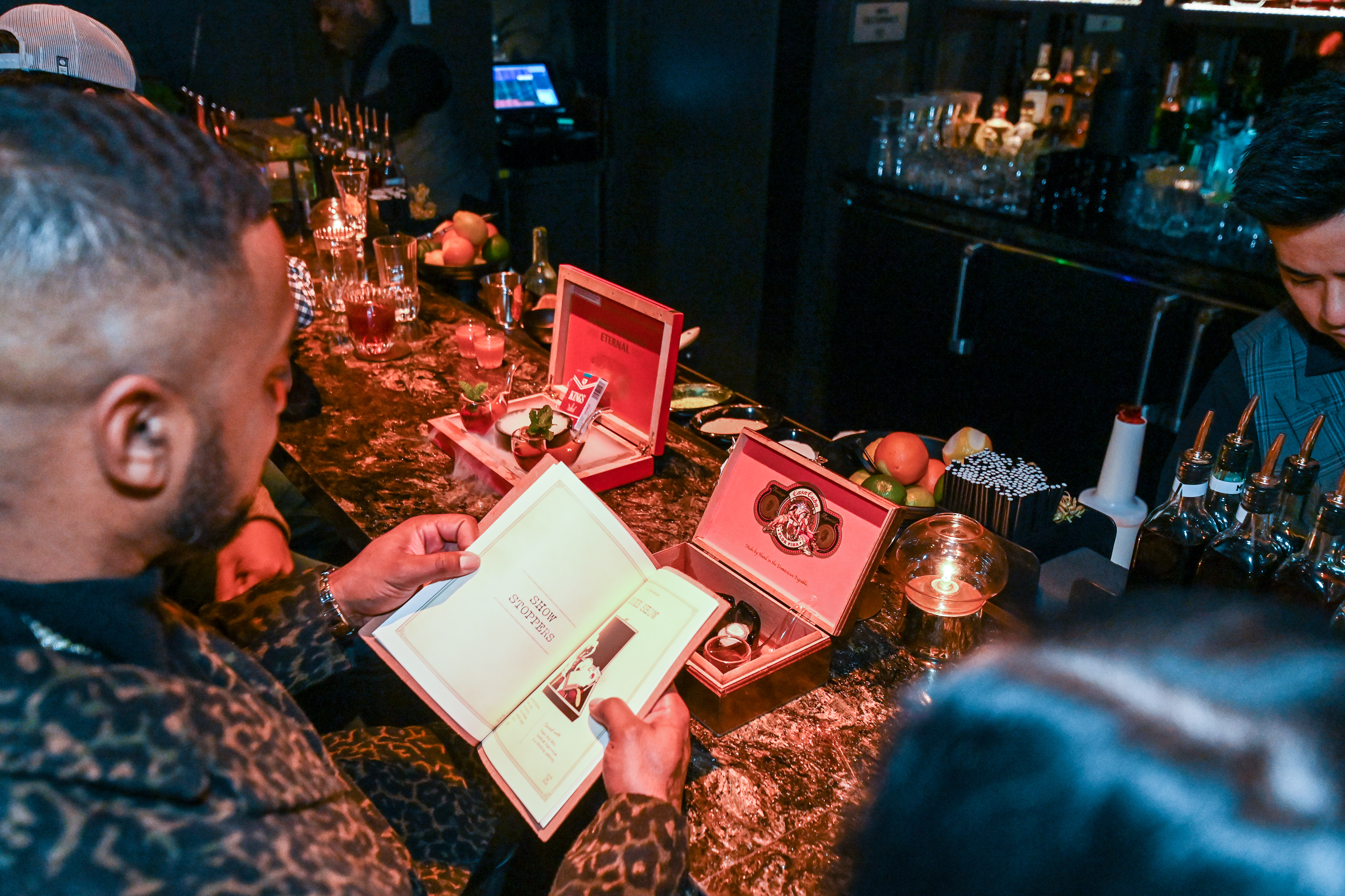 man ordering the smoke show cocktail at live music venue Easys 