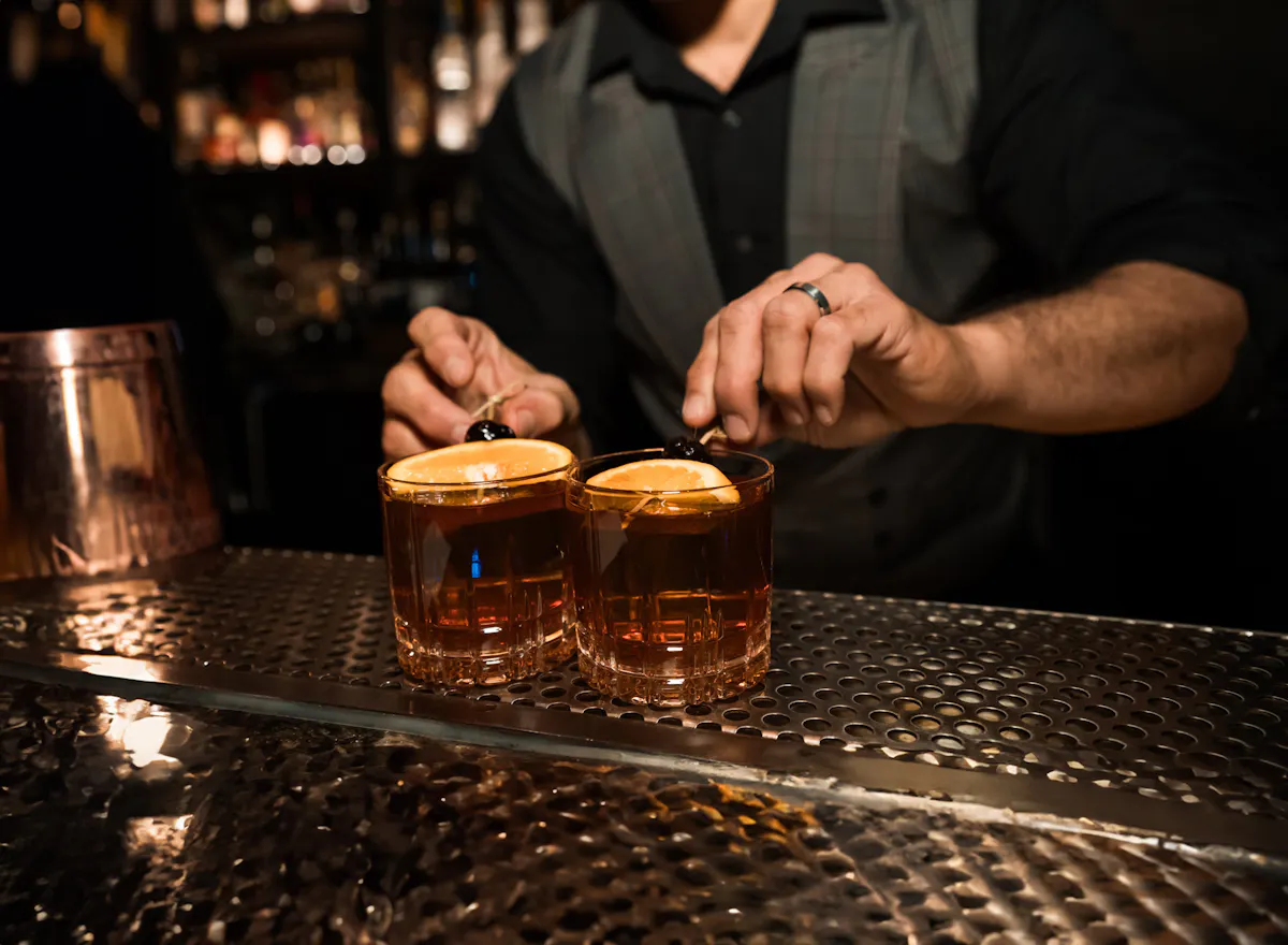 a man holding a spoon and a drink