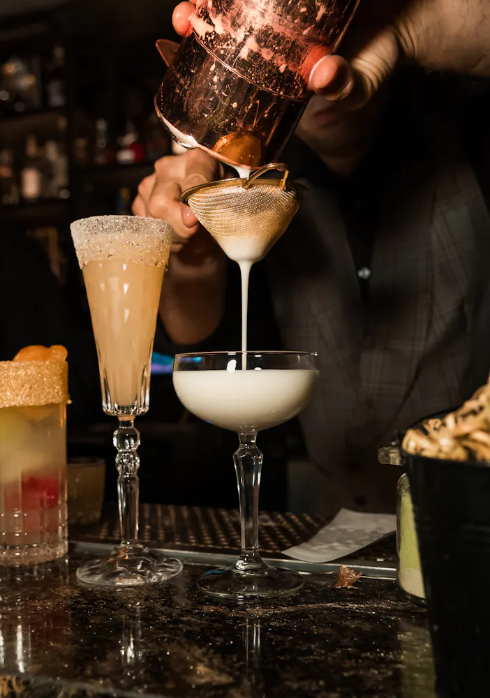 cocktail being poured into a martini glass at Las Vegas live music venue Easys