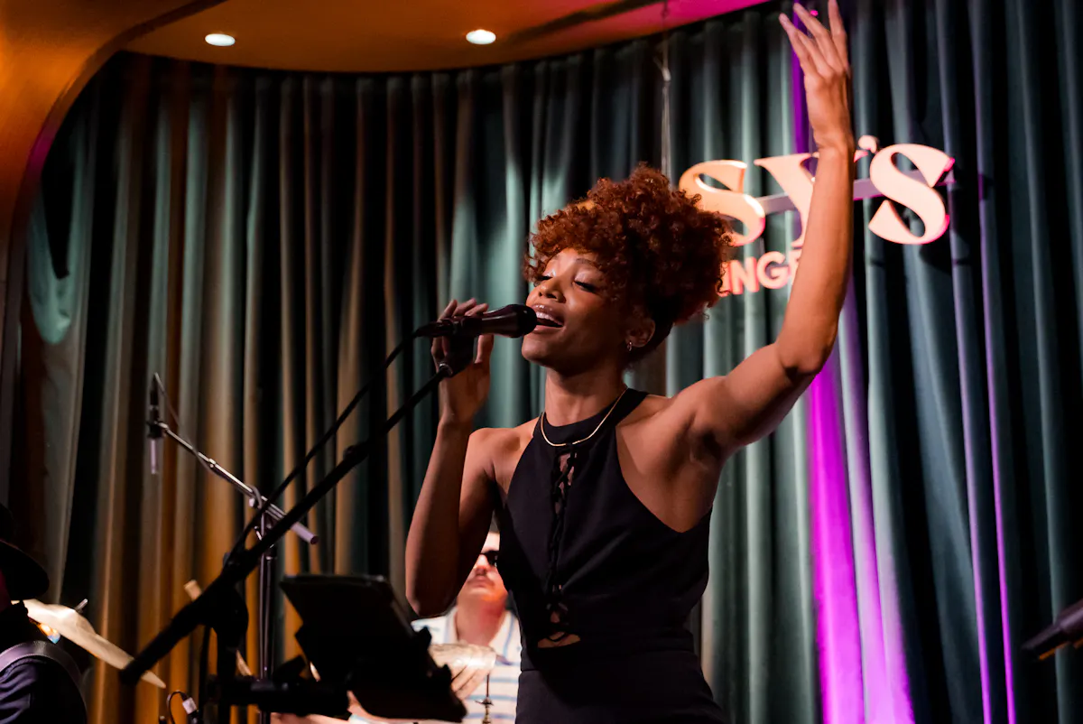 a woman singing into a microphone