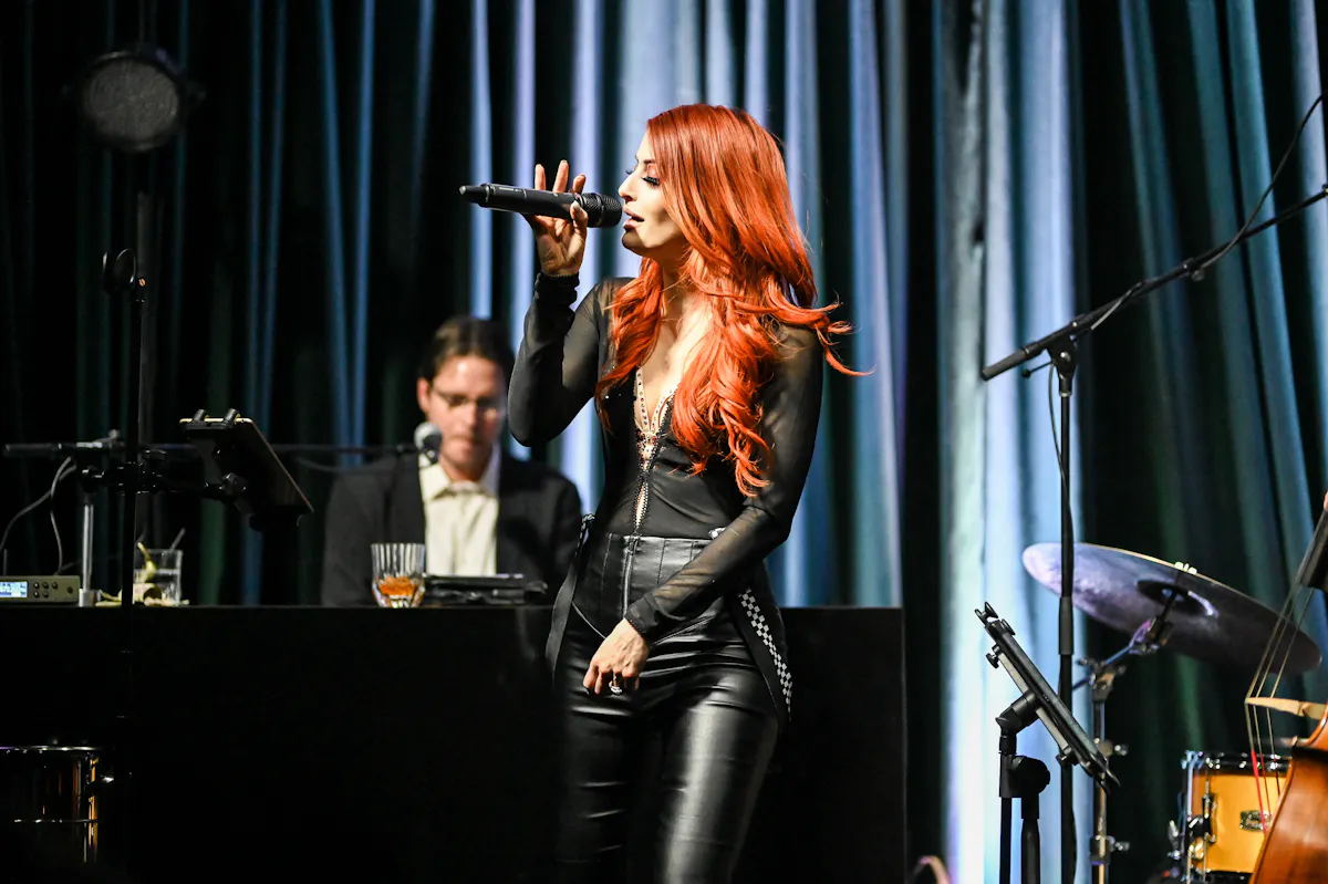 a woman singing into a microphone