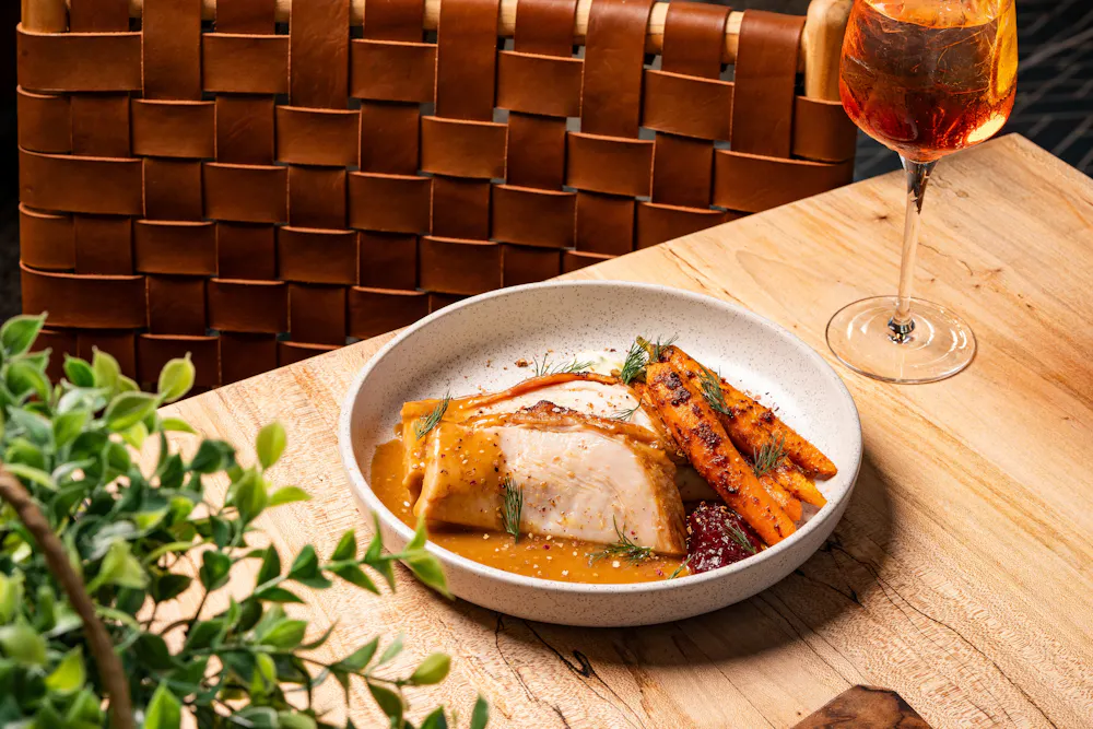 a plate of food and a glass of wine
