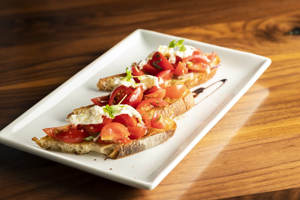 a plate of food sitting on top of a wooden cutting board