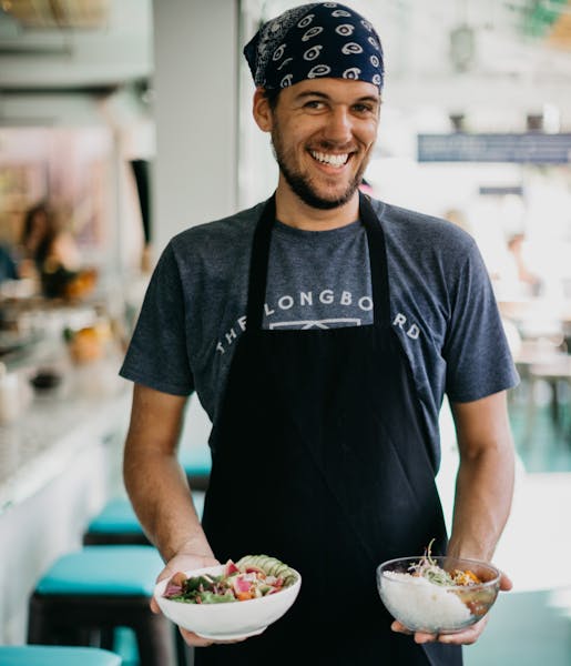 a man standing in front of a plate of food