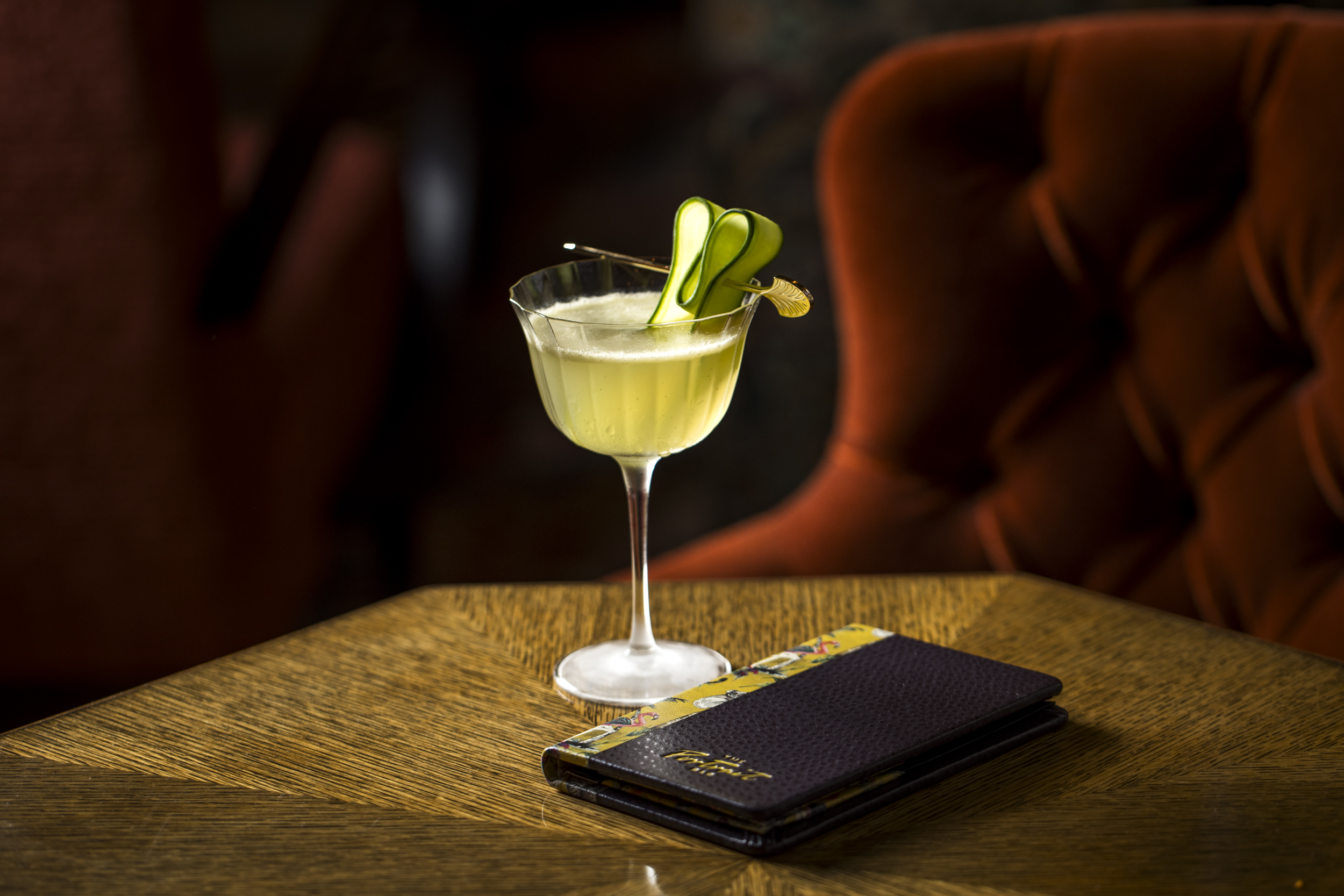 a glass of wine sitting on top of a wooden table