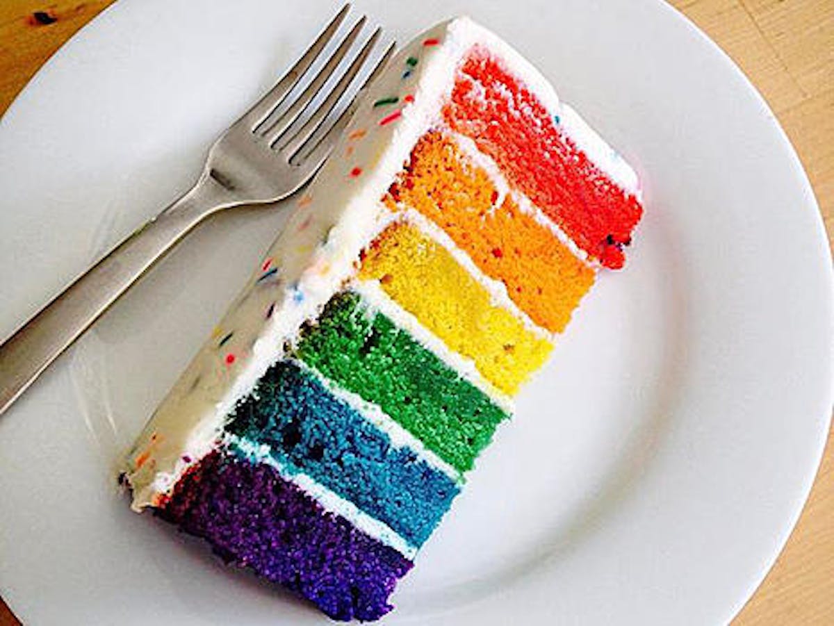 Rainbow cake with white frosting