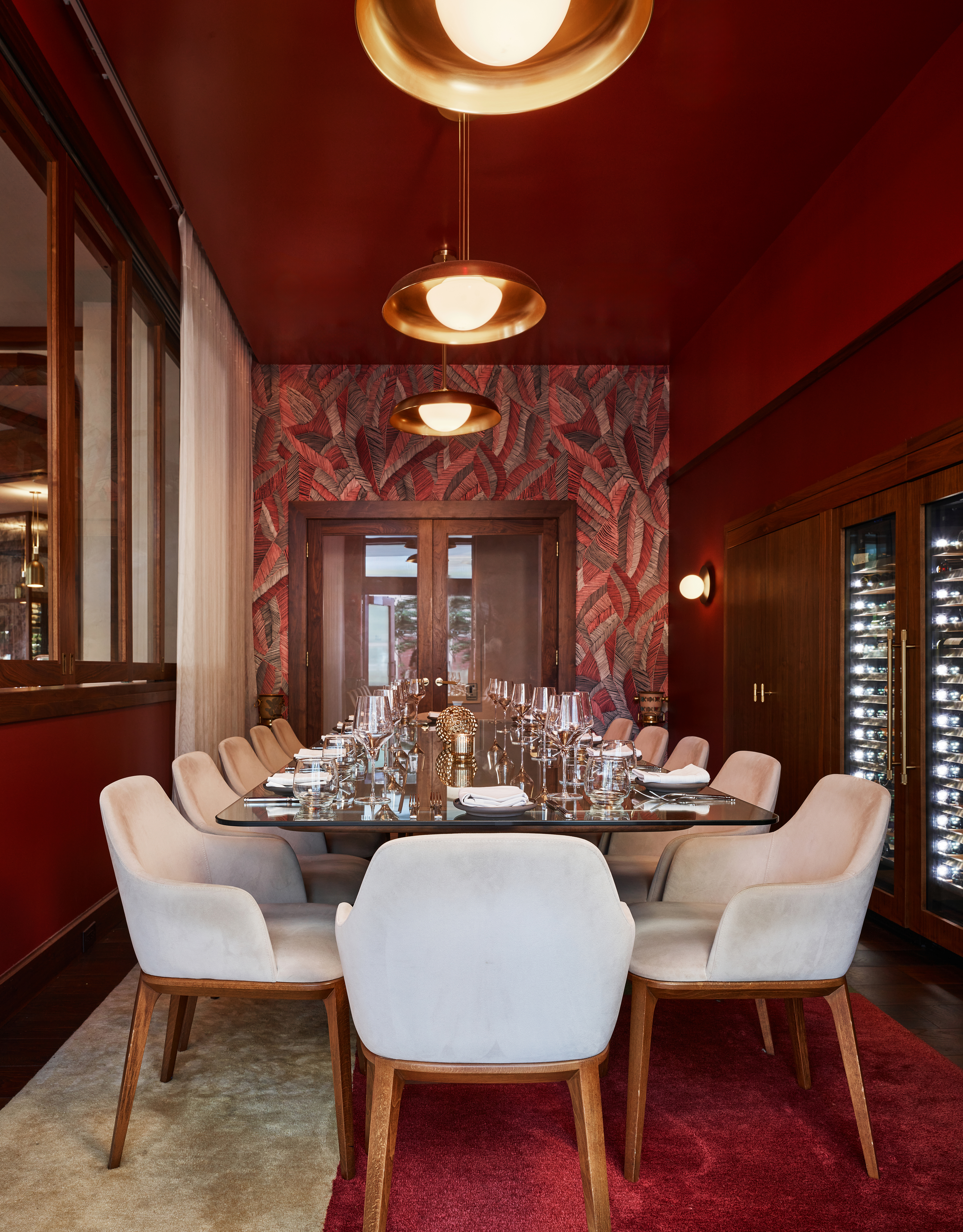 a dining room filled with furniture and a large window
