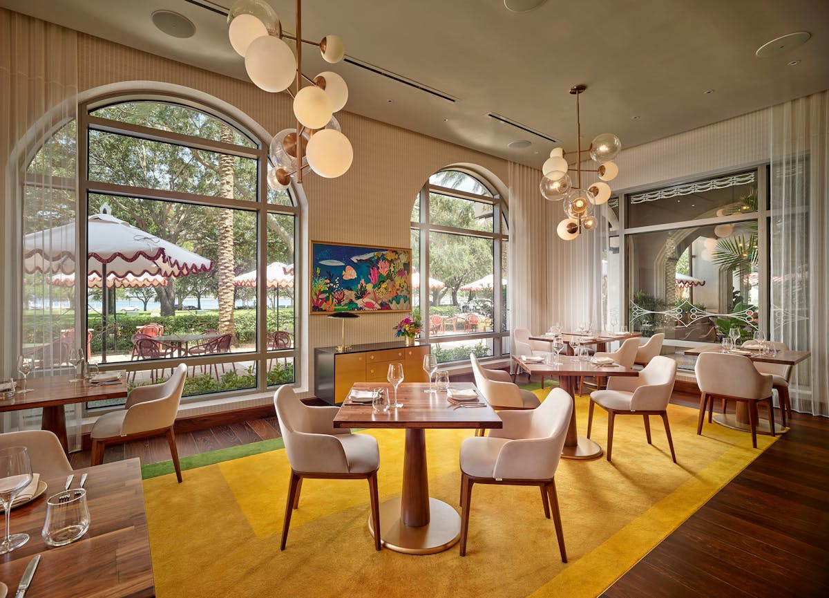 a living room filled with furniture and a large window