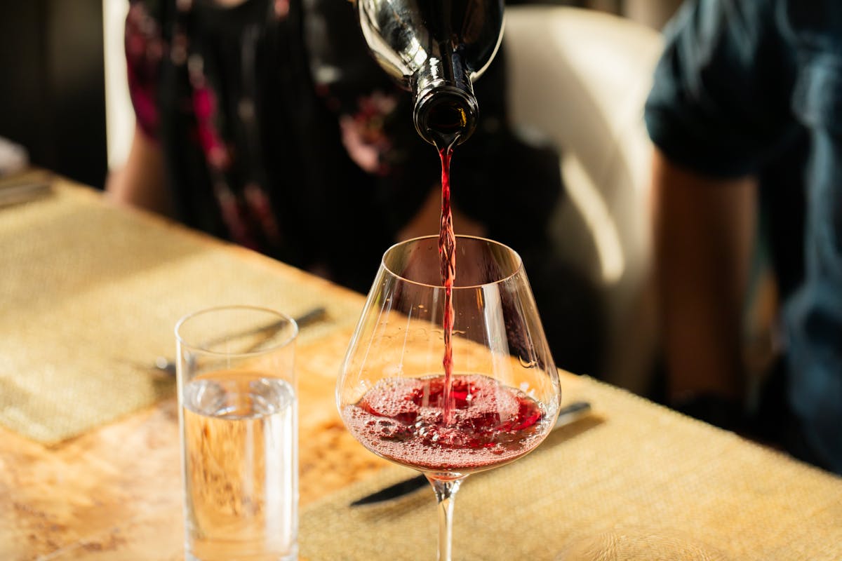 a close up of a wine glass sitting on a table