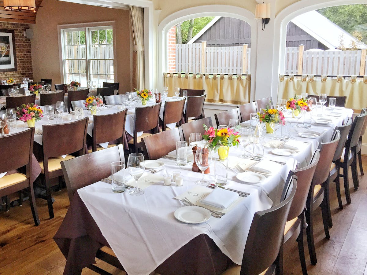 a dining room table in front of a window