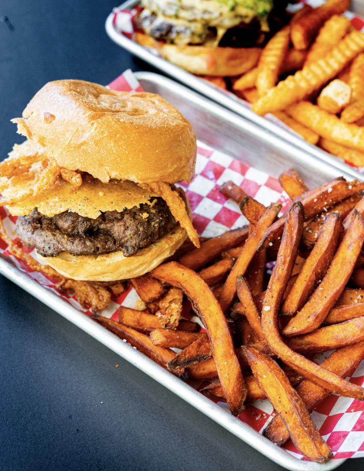 a burger and fries on a tray