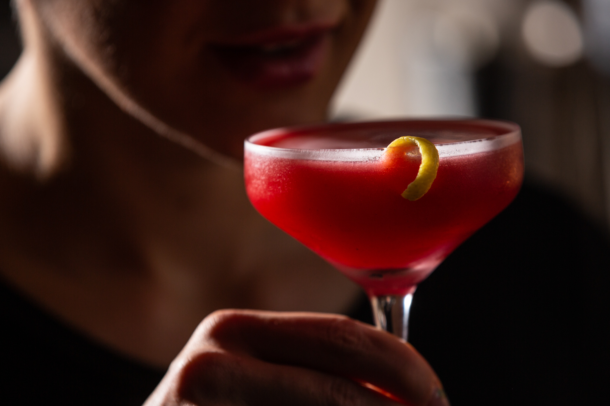 a close up of a person holding a wine glass