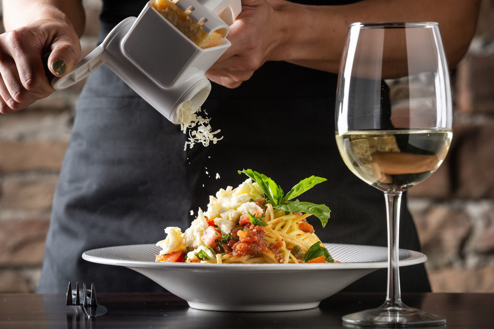 a person holding a wine glass on a table