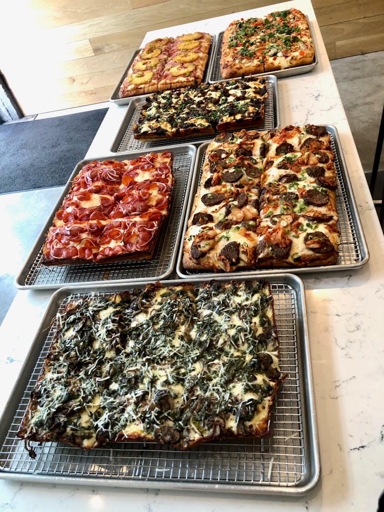 a pizza sitting on top of a stove