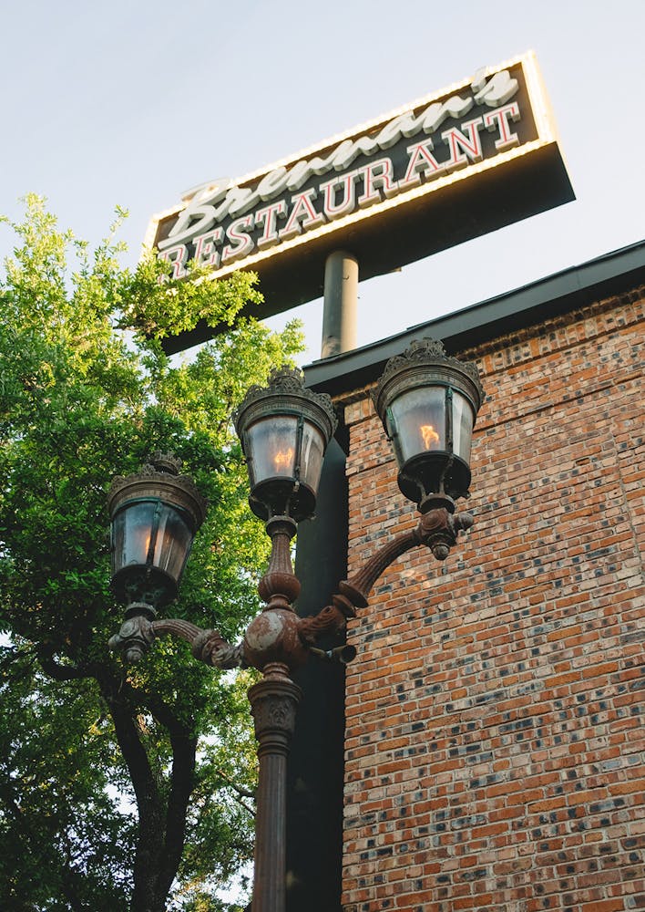 a sign in front of a brick building
