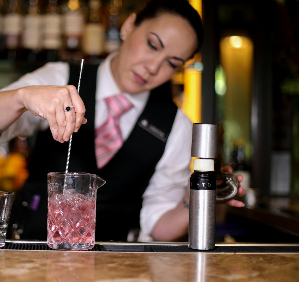 a person holding a glass of water on a table