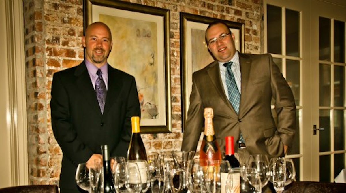 a group of people sitting at a table with wine glasses