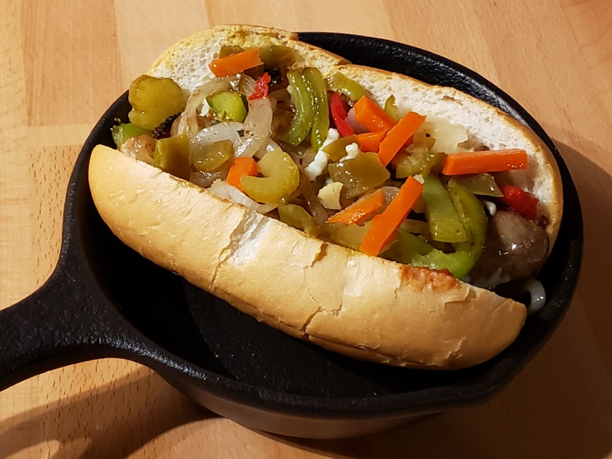 a hot dog on a wooden table