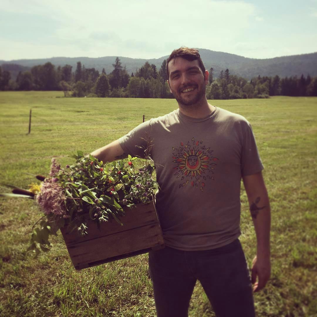 a man standing on top of a grass field posing for the camera