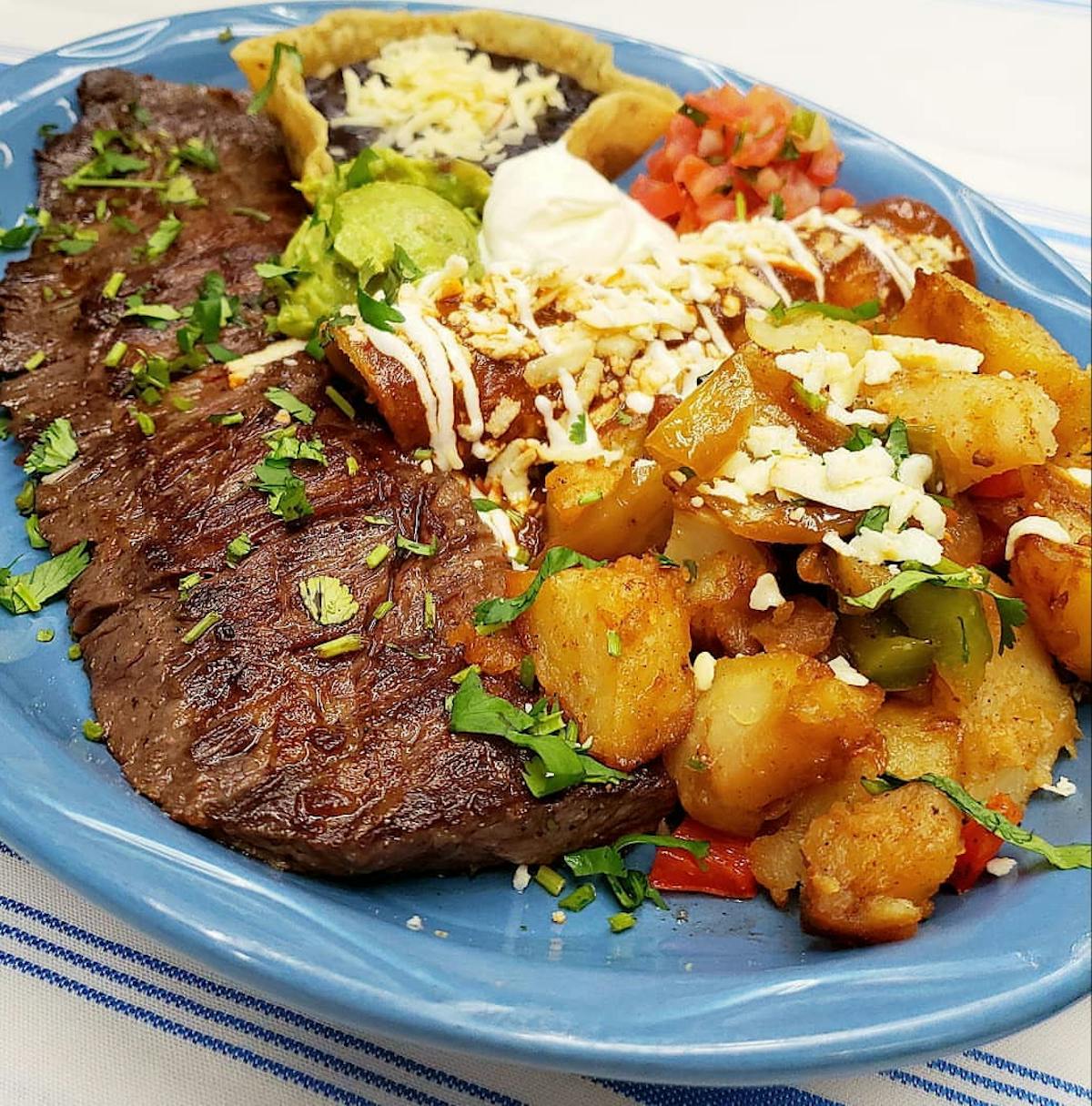 a white plate topped with meat and vegetables