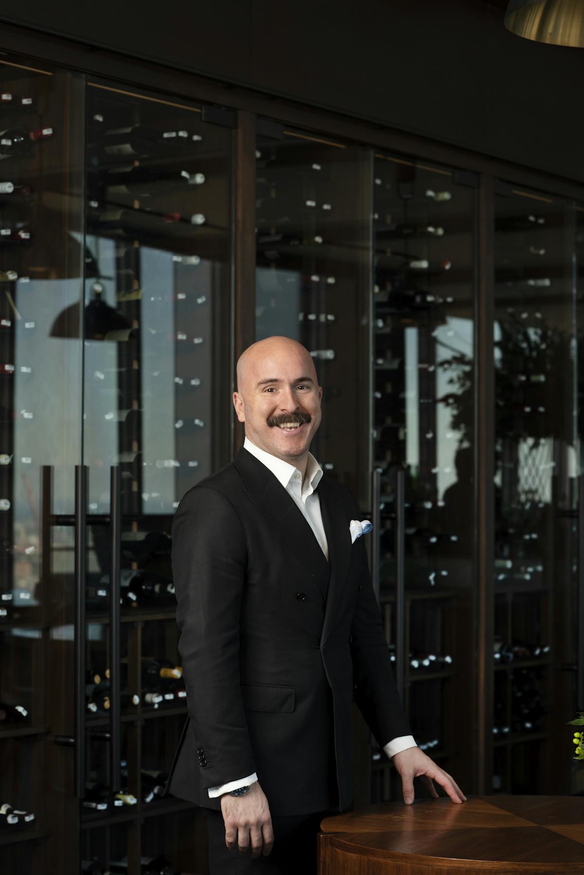 a man in a suit standing in front of a building