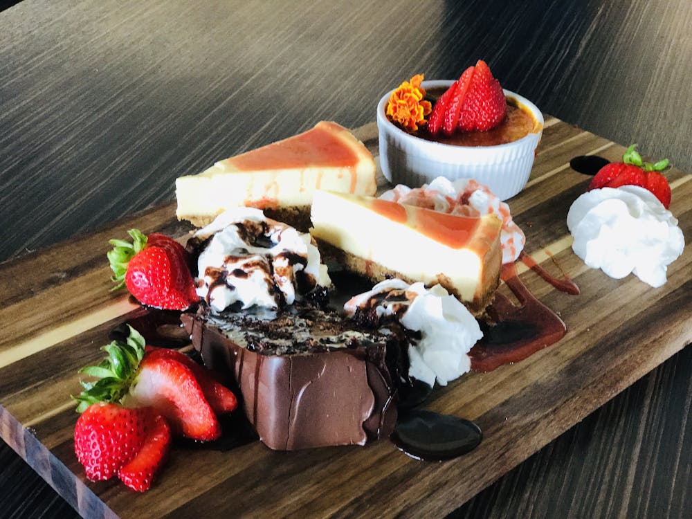 a cake with fruit on top of a wooden table